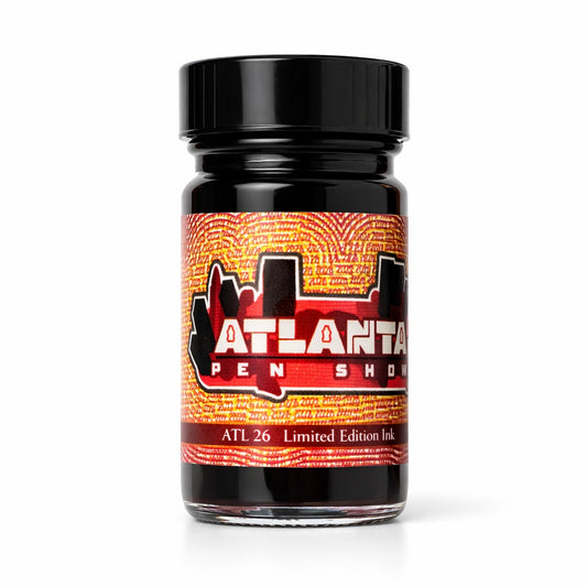 Jar of Atlanta Pen Show ink with a black lid on a white background